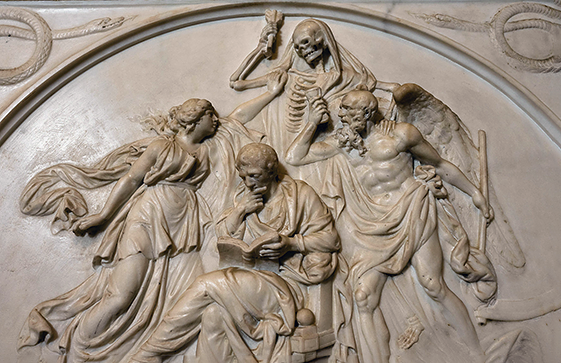 Memorial showing a man reading a book, surrounded by angels fighting death